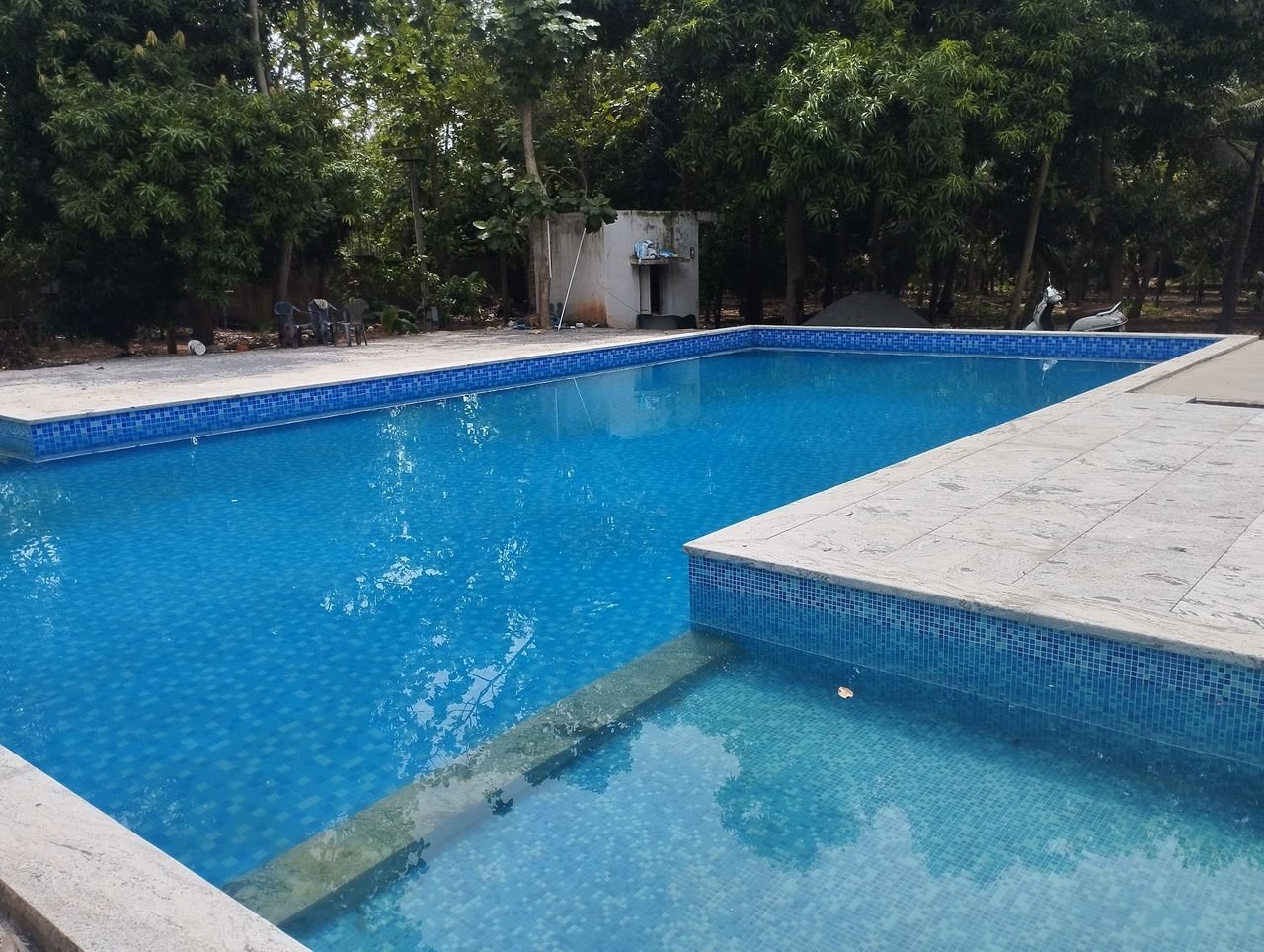 Clear pool water and paving at the pool edge