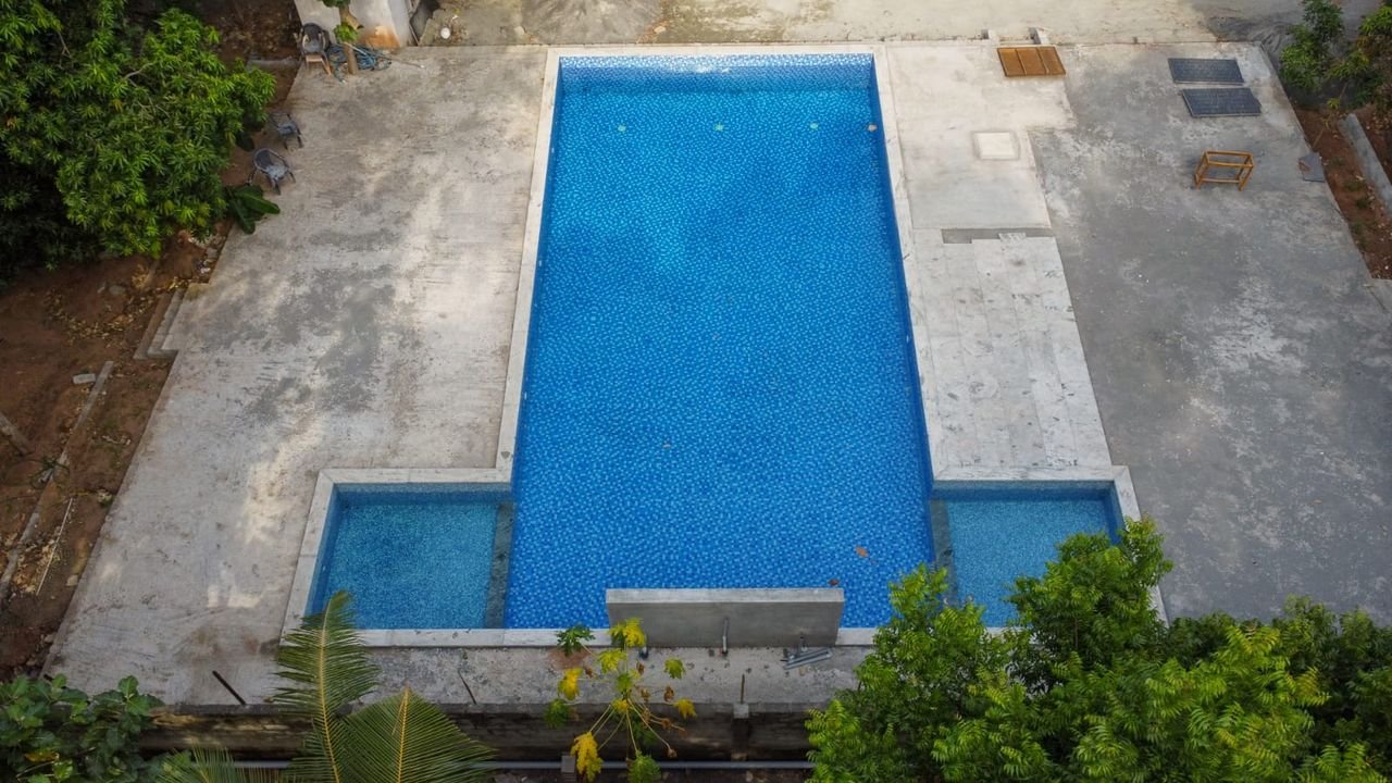 The swimming pool seen from above, surrounded by greenery